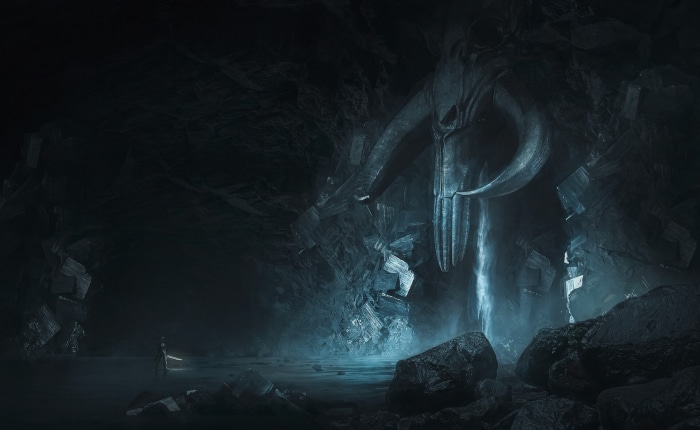 Din Djarin in a cave with a large skull