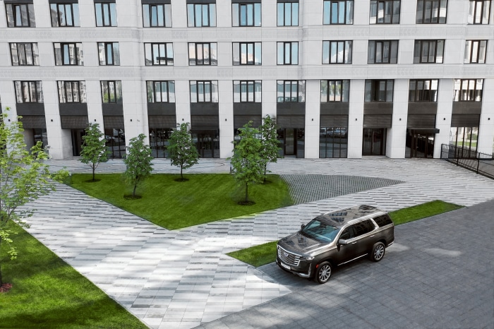 Cadillac Escalade 600 4K SUV parked in front of building