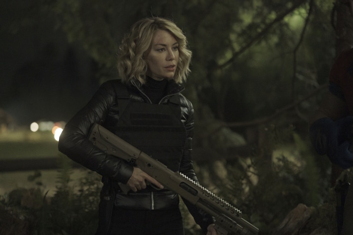 Emilia Harcourt from Peacemaker with a shotgun