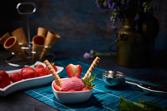 Strawberry ice cream with strawberries and wafer sticks