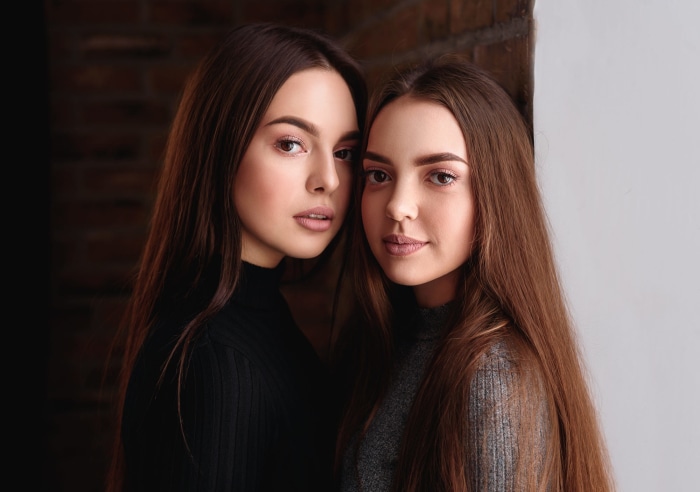 Two young women with long brown hair