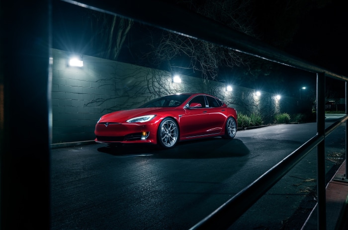 Red Tesla Model S parked at night