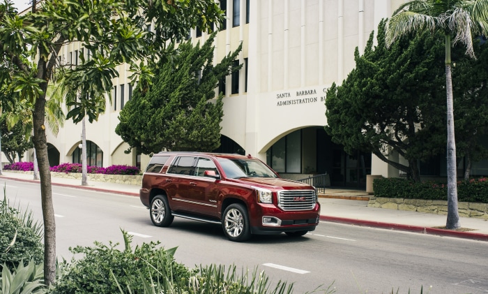 Red GMC Yukon Denali HD SUV on Street