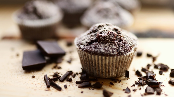 Chocolate cupcakes with powdered sugar and chocolate pieces