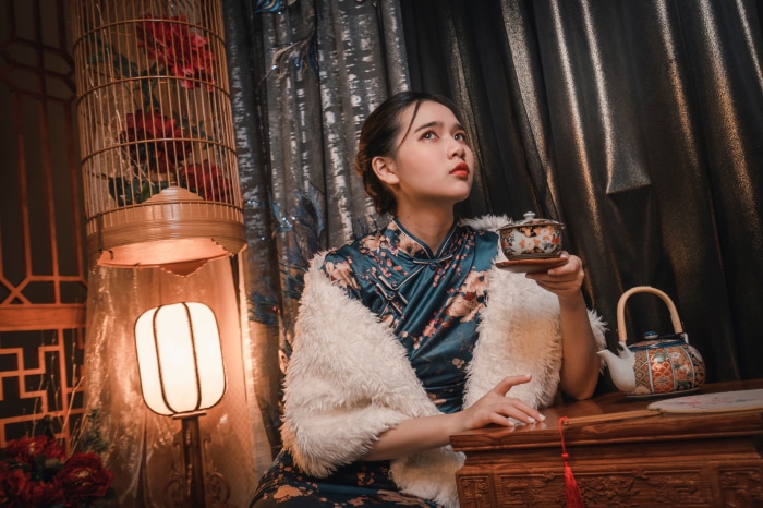 Woman in traditional dress holding tea cup
