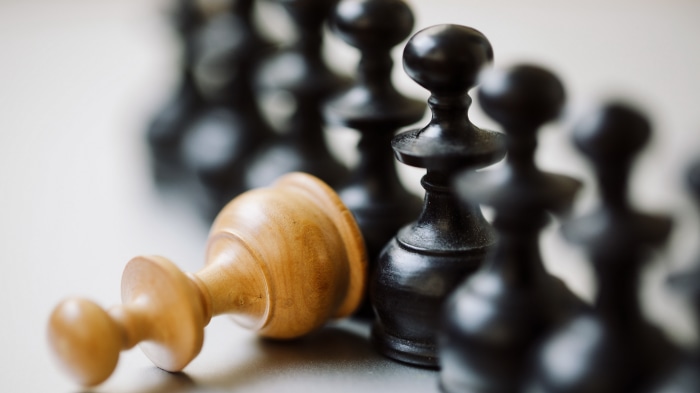 Chess pieces, one fallen pawn