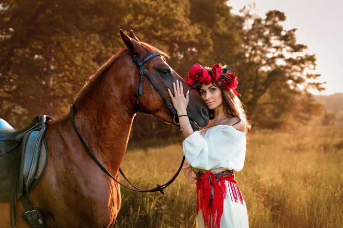 Woman with flower wreath and horse