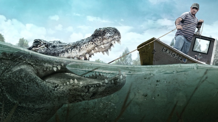 Swamp People: Man pulling boat with alligator