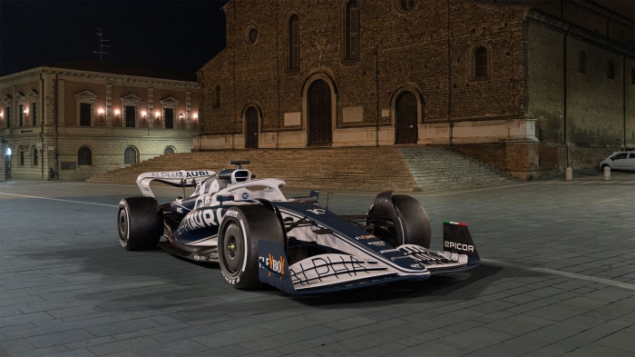 AlphaTauri F1 car on a cobblestone square at night