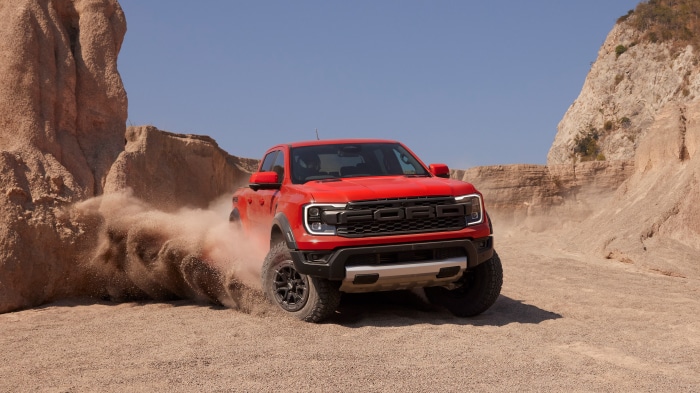 Red Ford Ranger Raptor driving through desert