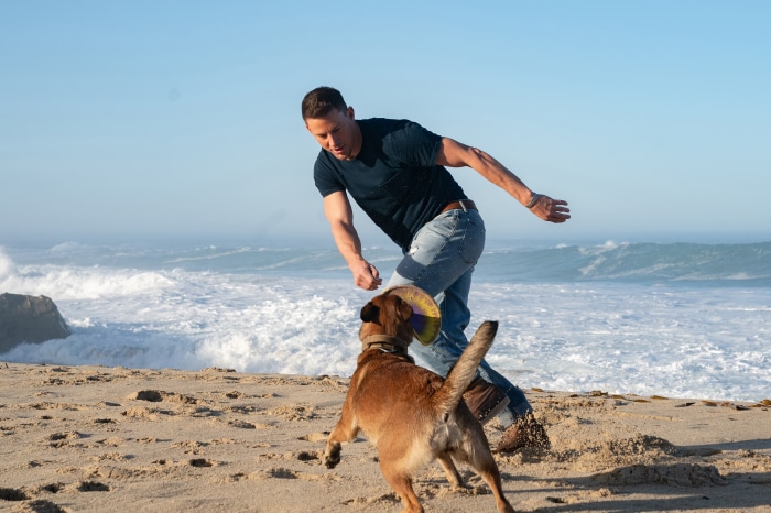 Channing Tatum playing with dog on beach 4K