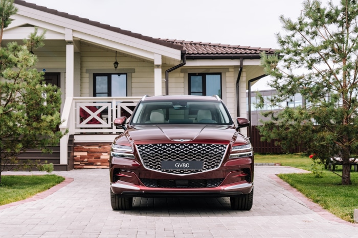 Genesis GV80 SUV parked in front of a house