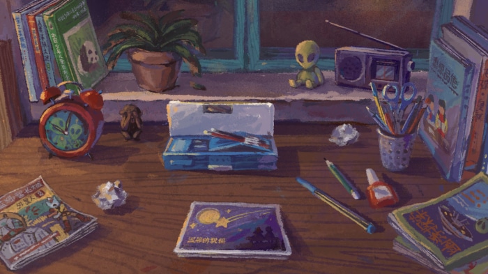 Desk with books, alarm clock, and art supplies