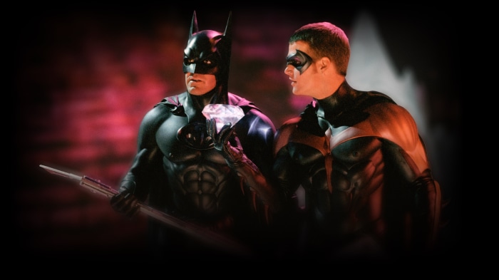 Batman and Robin holding a diamond