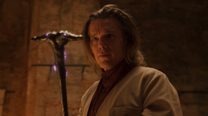 Arthur Harrow from Moon Knight holding a staff