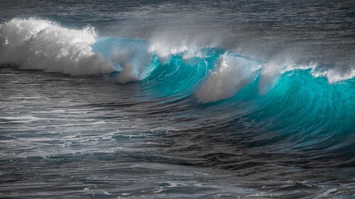 Turquoise wave crashing with white foam
