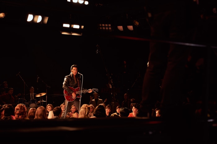 Austin Butler as Elvis Presley performing on stage