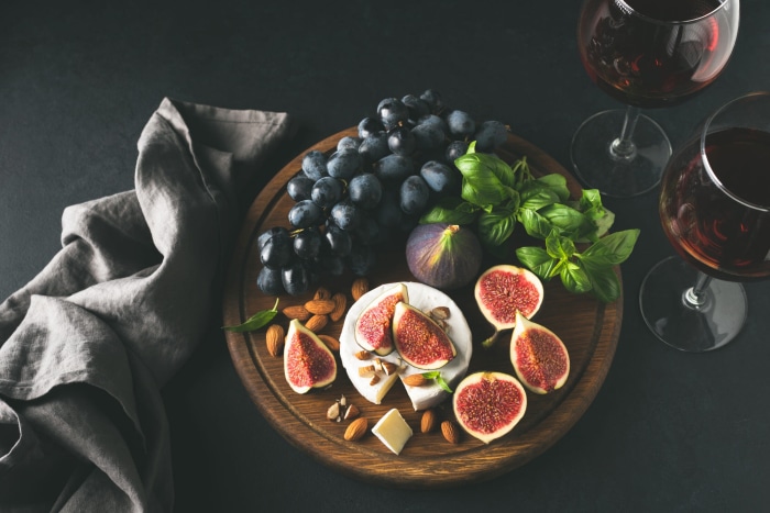 Cheese and fruit platter with red wine