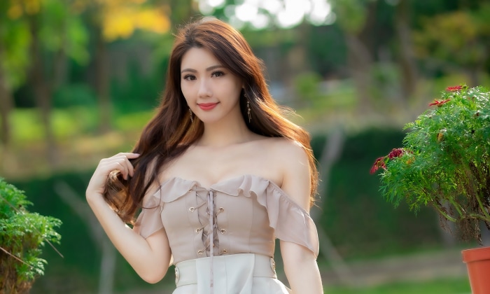 Asian woman with long brown hair outdoors