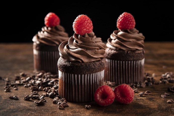 Chocolate cupcakes with raspberries and cocoa nibs