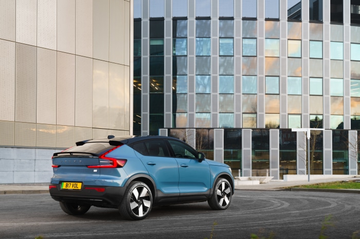 Blue Volvo C40 Recharge SUV parked near modern building