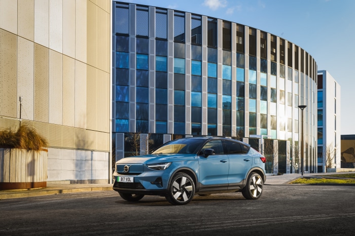 Blue Volvo C40 Recharge SUV parked outside modern building