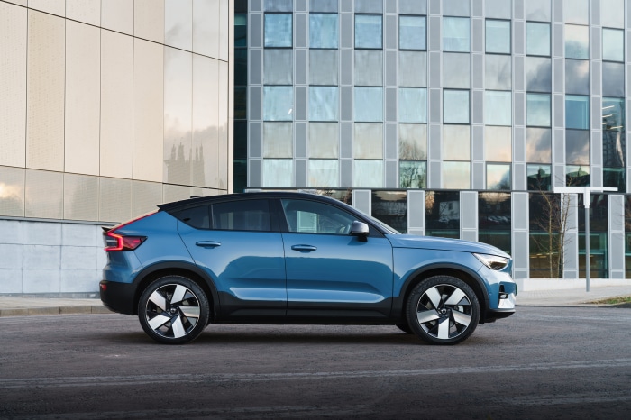 Blue Volvo C40 Recharge parked in front of a modern building