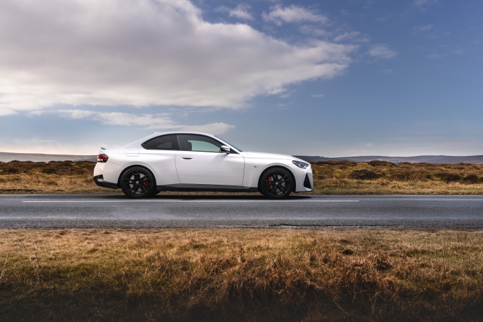 White BMW 220i Coupé M Sport on a road