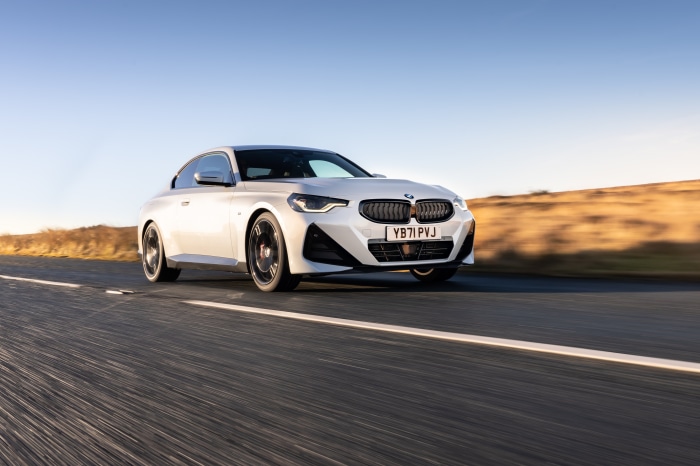 White BMW 220i Coupe M Sport driving on road
