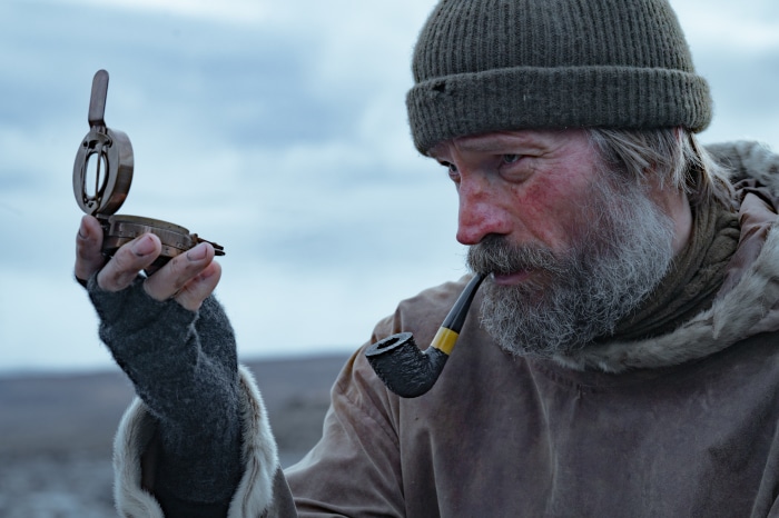 Man from Against The Ice holding a compass
