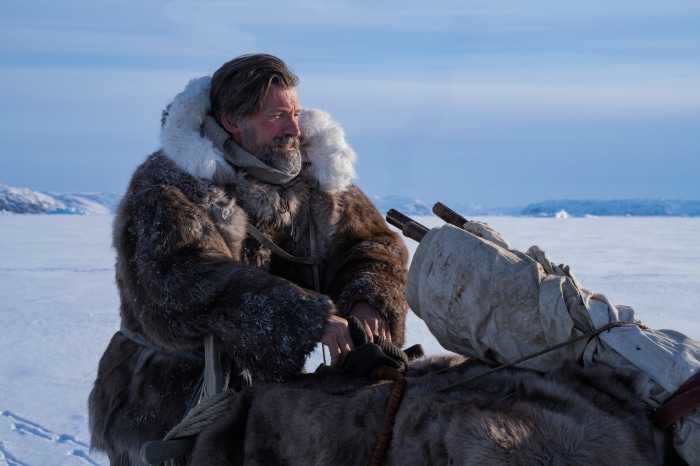 Man in fur coat in snowy landscape