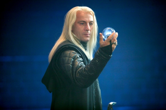 Lucius Malfoy from Harry Potter holding a crystal ball