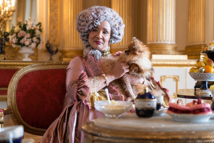 Queen Charlotte from Bridgerton holding a Pomeranian dog