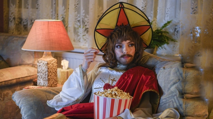 Villanelle from Killing Eve watching TV with popcorn