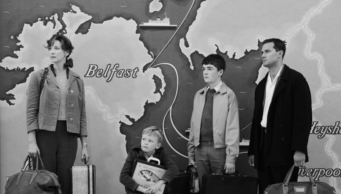 Family in front of map of Ireland and UK