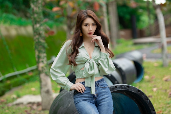 Asian woman with brunette hair in a park