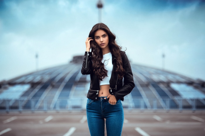 Laura Theresa wearing a black leather jacket and blue jeans