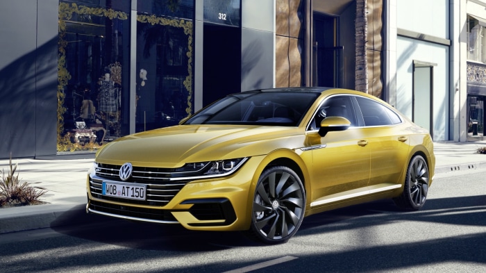 Yellow Volkswagen Arteon parked on a city street