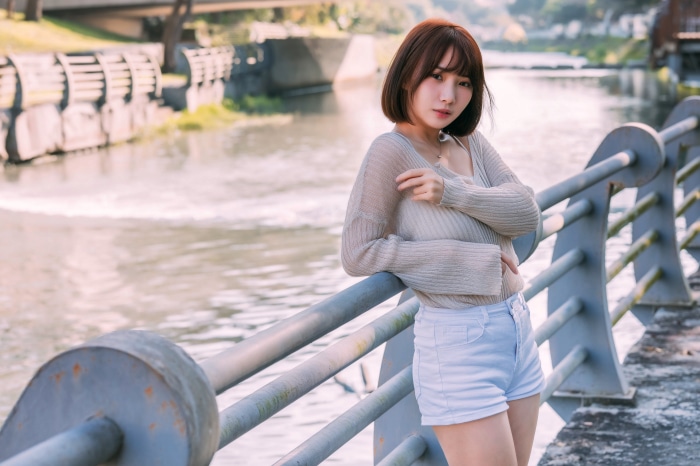 Asian woman with short hair wearing shorts