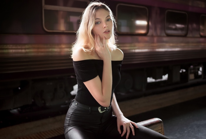 Model posing by a train