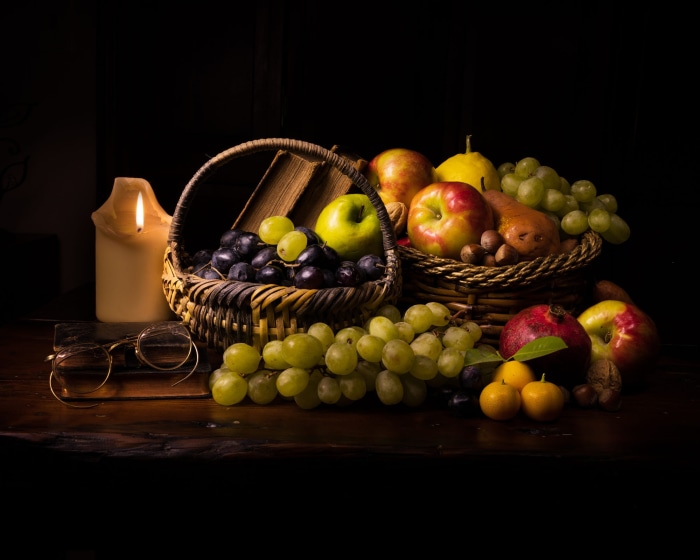 Still life with fruits, books, and candle