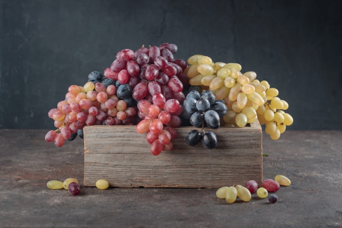 Assortment of Grapes in a Wooden Crate