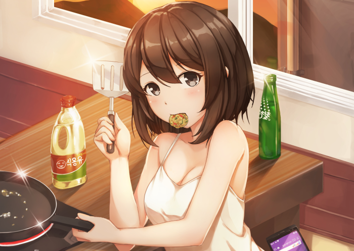 Girl cooking with a spatula and food in her mouth