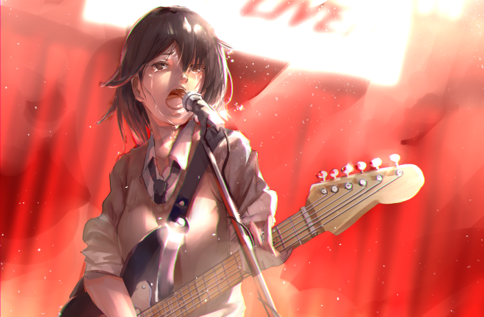 Girl singing and playing guitar on stage