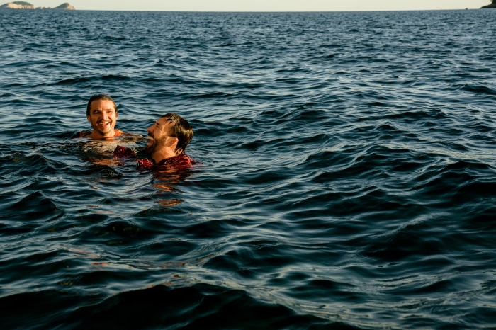 Nicolas Cage and Pedro Pascal swimming in the ocean