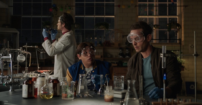 Andrew Garfield, Tobey Maguire, and Jacob Batalon in a lab