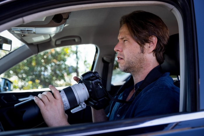 Man with camera in car