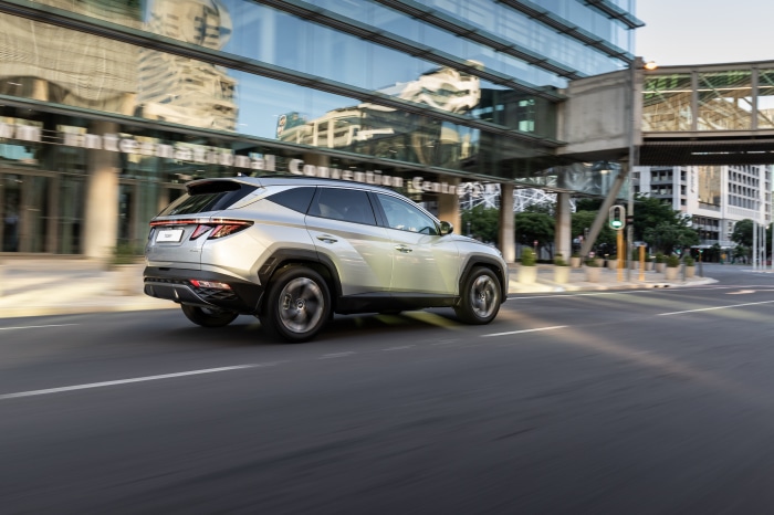 Silver Hyundai Tucson driving on a city street