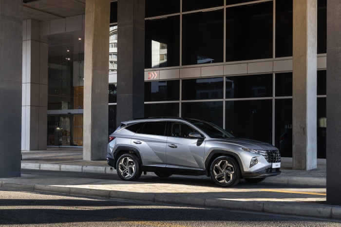 Silver Hyundai Tucson SUV parked near a modern building