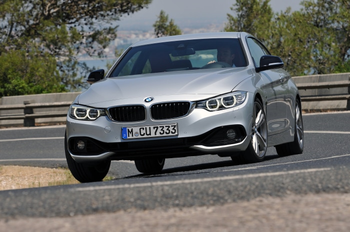 Silver BMW 435i Coupe Sport Line AT driving on road